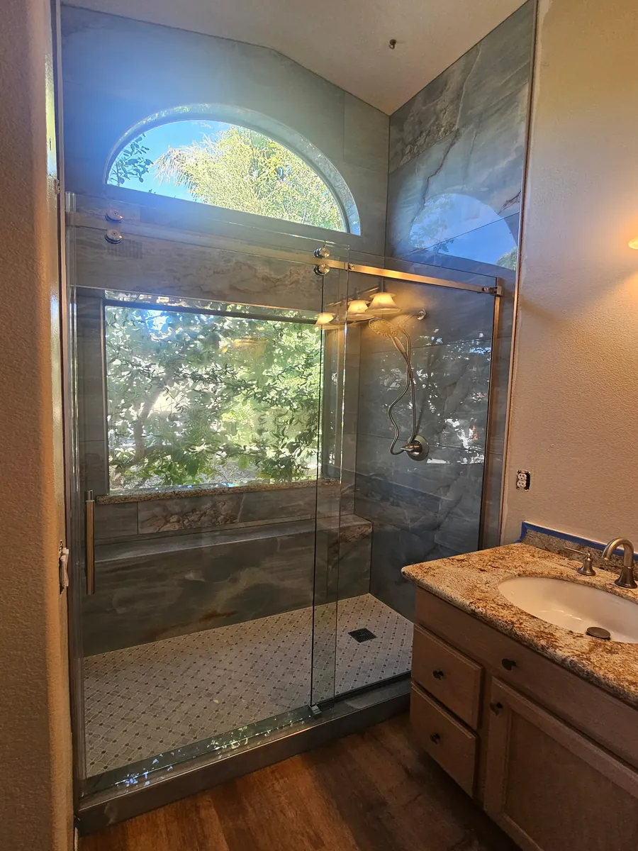 Luxury Stone-Look Tile Shower with Arched Window Phoenix AZ | Albaner Tile and Stone