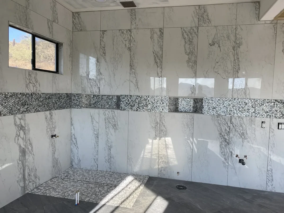 Large Format Calacatta Marble Shower with Penny Tile Niche | Albaner Tile and Stone Phoenix
