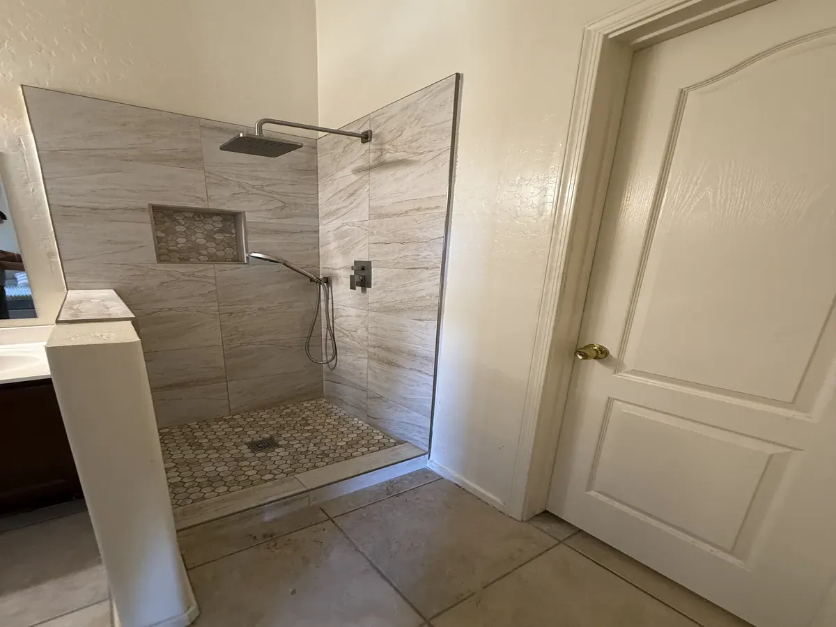 Travertine Porcelain Walk-In Travertine-Look Porcelain Walk-In Shower with Hex Mosaic Niche Fountain Hills AZ | Albaner Tile and Stone